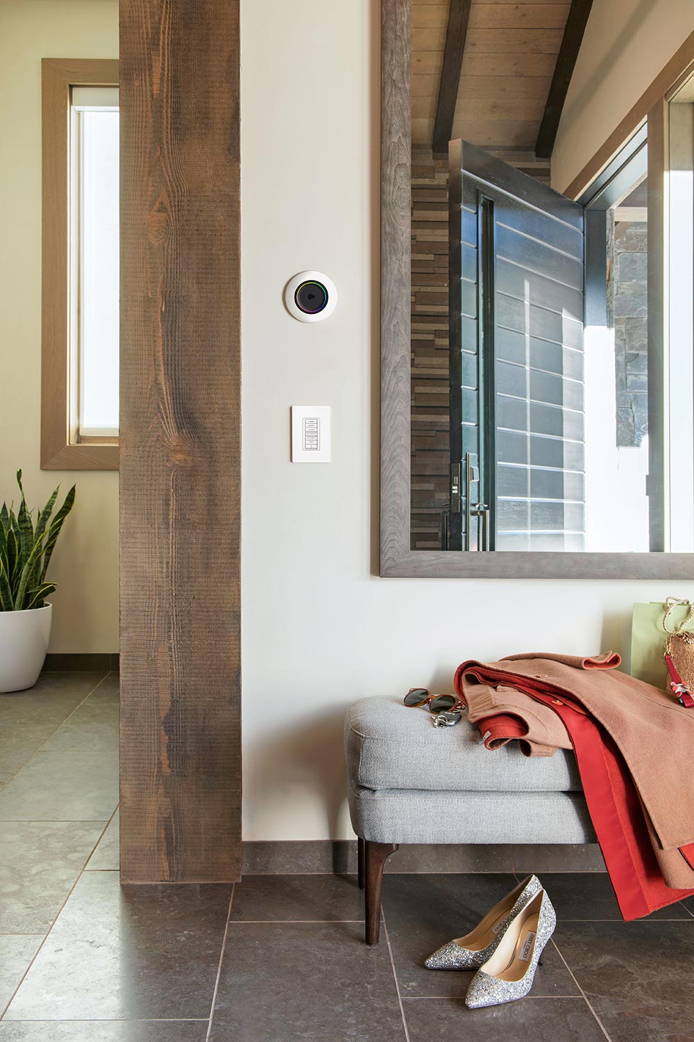 Smart home lighting control panel and circular dimmer on a white wall